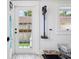 Functional mud room with tiled floor, window, and door to outdoors at 4913 N Central Ave, Tampa, FL 33603