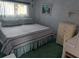 Comfortable bedroom with a large bed, soft bedding, and natural light streaming through the window at 51 Lexington Ct # 13, Palm Harbor, FL 34684