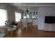 Charming dining room featuring a stylish dining set, built-in cabinets, and bright natural light from large windows at 51 Lexington Ct # 13, Palm Harbor, FL 34684