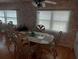 Elegant dining area with a glass top table, stylish chairs, and plenty of natural light from large windows at 51 Lexington Ct # 13, Palm Harbor, FL 34684
