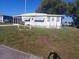 Charming single-story home featuring a decorative lawn, a small porch, and ample natural light at 51 Lexington Ct # 13, Palm Harbor, FL 34684