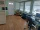 Functional office space with a comfortable chair, desk, and ample natural light from the multiple windows at 51 Lexington Ct # 13, Palm Harbor, FL 34684