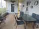 Relaxing screened-in porch with dining set, perfect for enjoying the outdoors while protected from the elements at 51 Lexington Ct # 13, Palm Harbor, FL 34684