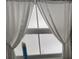 Window with white curtains, providing privacy and natural light at 51 Lexington Ct # 13, Palm Harbor, FL 34684