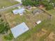 Aerial view of a property featuring multiple structures and a large fenced lot, presenting investment and development opportunities at 5109 Horton Rd, Plant City, FL 33567