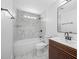 Modern bathroom with a sleek vanity and white marble tile in the shower and tub area at 5109 Horton Rd, Plant City, FL 33567