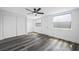 Bedroom with new gray wood flooring, ceiling fan, freshly painted walls, and closet space at 5109 Horton Rd, Plant City, FL 33567
