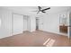Spacious bedroom with tile flooring, ceiling fan, and access to bathroom at 5109 Horton Rd, Plant City, FL 33567