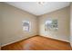 Bedroom with wood-look floor and a boarded window at 5109 Horton Rd, Plant City, FL 33567