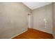 An empty room features wood-look flooring, neutral walls and a door at 5109 Horton Rd, Plant City, FL 33567
