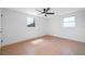 Well-lit bedroom with tiled floors, ceiling fan, and windows at 5109 Horton Rd, Plant City, FL 33567