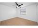 Bright bedroom with a ceiling fan, neutral paint, window with blinds, and tan tile flooring at 5109 Horton Rd, Plant City, FL 33567