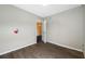 Bedroom with neutral-toned walls and updated flooring with an entrance to another room at 5109 Horton Rd, Plant City, FL 33567