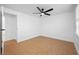 Bedroom features a ceiling fan, fresh neutral paint, tan tile flooring, and modern finishes at 5109 Horton Rd, Plant City, FL 33567