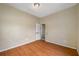 An empty room features wood-look flooring, neutral walls and a door at 5109 Horton Rd, Plant City, FL 33567