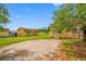 Side view of the home and surrounding lot shows lawn and some outbuildings at 5109 Horton Rd, Plant City, FL 33567
