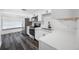 Updated kitchen features stainless steel appliances, white cabinets, stone countertops and dark flooring at 5109 Horton Rd, Plant City, FL 33567