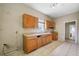 A kitchen with oak cabinets, a window, and linoleum tile flooring at 5109 Horton Rd, Plant City, FL 33567