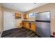 The kitchen features wood cabinetry, stainless steel refrigerator, and matching dark wood flooring at 5109 Horton Rd, Plant City, FL 33567