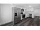 Modern kitchen featuring stainless steel appliances, sleek white cabinetry, and updated fixtures at 5109 Horton Rd, Plant City, FL 33567