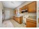 A kitchen with oak cabinets, a window, and linoleum tile flooring at 5109 Horton Rd, Plant City, FL 33567
