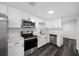 Renovated kitchen features stainless steel appliances, white cabinets, and stone countertops at 5109 Horton Rd, Plant City, FL 33567