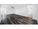 Open concept living room with new dark wood flooring, ceiling fan, and white trim at 5109 Horton Rd, Plant City, FL 33567