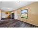 The living room has dark floors and a large window for lots of natural light at 5109 Horton Rd, Plant City, FL 33567