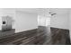 Bright, open living room featuring sleek, modern flooring and fresh, neutral wall color at 5109 Horton Rd, Plant City, FL 33567