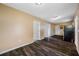 A partially renovated living room with laminate flooring and multiple entry ways at 5109 Horton Rd, Plant City, FL 33567