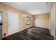 Spacious living room with hardwood floors, natural light, and a white front door at 5109 Horton Rd, Plant City, FL 33567