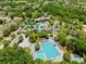 Aerial view of the community pool and amenity center surrounded by lush landscaping at 5314 Alafia Falls Dr, Lithia, FL 33547