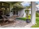 Outdoor patio with a dining table and comfortable seating under a covered porch at 5314 Alafia Falls Dr, Lithia, FL 33547
