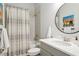 This bathroom features a tub and shower combination and a decorative mirror at 5314 Alafia Falls Dr, Lithia, FL 33547
