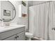 This bathroom features a tub/shower combo and a gray vanity with a white countertop at 5314 Alafia Falls Dr, Lithia, FL 33547