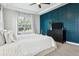 This bedroom features an accent wall, tray ceiling, and lots of natural light at 5314 Alafia Falls Dr, Lithia, FL 33547