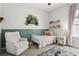 A cozy bedroom features a neutral color palette and a comfortable chair at 5314 Alafia Falls Dr, Lithia, FL 33547