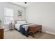 A simple bedroom features a window and a bed with a wooden chest at the foot at 5314 Alafia Falls Dr, Lithia, FL 33547