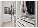 This is a walk-in closet with custom shelving and storage drawers at 5314 Alafia Falls Dr, Lithia, FL 33547