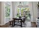 Dining area filled with natural light, a rustic table, and a view of the outdoor patio at 5314 Alafia Falls Dr, Lithia, FL 33547