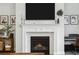 Close-up of a modern fireplace with decorative mantle, integrated TV, and views of the living space at 5314 Alafia Falls Dr, Lithia, FL 33547