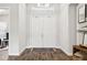Bright foyer featuring beautiful wood floors, an elegant chandelier, and a view of the home's stylish interior at 5314 Alafia Falls Dr, Lithia, FL 33547