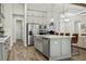 Open concept kitchen with stainless steel appliances, an island with seating, and plenty of cabinet space at 5314 Alafia Falls Dr, Lithia, FL 33547