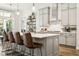 Modern kitchen featuring a large island with bar seating, stainless steel appliances, and stylish pendant lighting at 5314 Alafia Falls Dr, Lithia, FL 33547