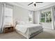 Comfortable main bedroom with plush carpeting, neutral colors, and large windows offering natural light at 5314 Alafia Falls Dr, Lithia, FL 33547