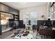 This home office features built-in shelving, wood floors, and two work spaces at 5314 Alafia Falls Dr, Lithia, FL 33547