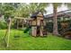 Backyard playground features a two story playhouse, slide, and a swing at 5314 Alafia Falls Dr, Lithia, FL 33547