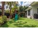 Backyard playground includes a slide, swing, and a playhouse at 5314 Alafia Falls Dr, Lithia, FL 33547