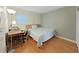 Cozy bedroom featuring hardwood floors, a desk, and a serene view at 6067 43Rd N Ter, Kenneth City, FL 33709