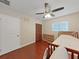 Bright bedroom with hardwood floors, ceiling fan, and closet space, perfect for relaxation at 6067 43Rd N Ter, Kenneth City, FL 33709